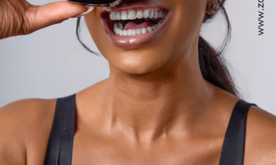 Smiling woman holding Zaron compact powder.