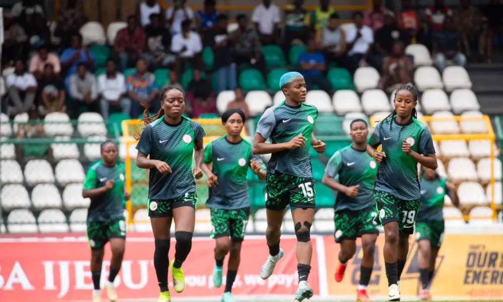 Nigerian women's soccer team training on field.