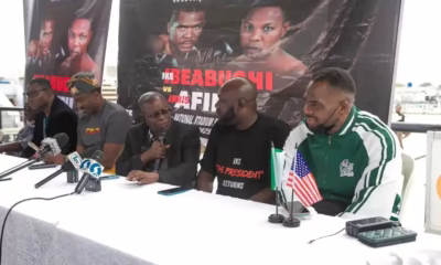 Boxing press conference with speakers and microphones.