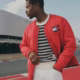 Man wearing stylish red jacket outdoors.